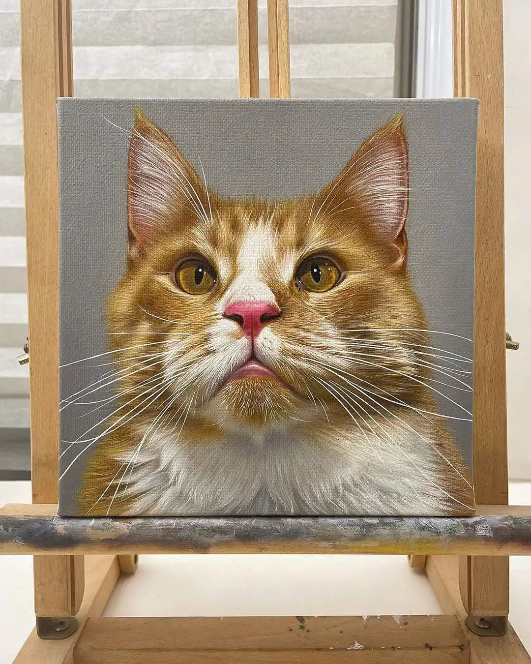 A hyper-realistic orange tabby oil portrait of a cat on premium canvas
